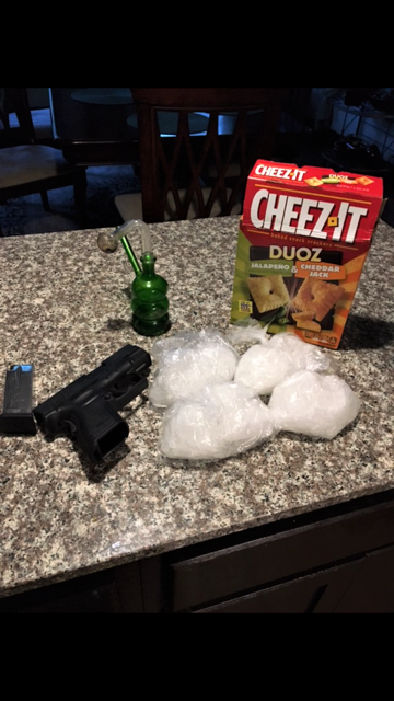 A cheez-it box, cocaine bags and a handgun.