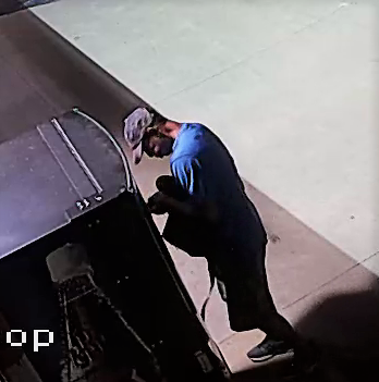 Surveillance footage of male breaking into van.