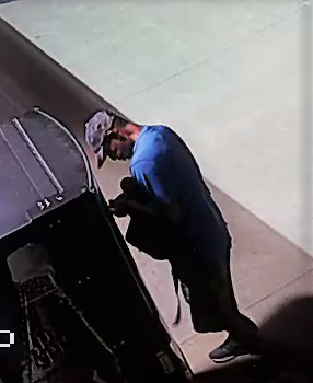 Surveillance footage of male attempting to break into a van.