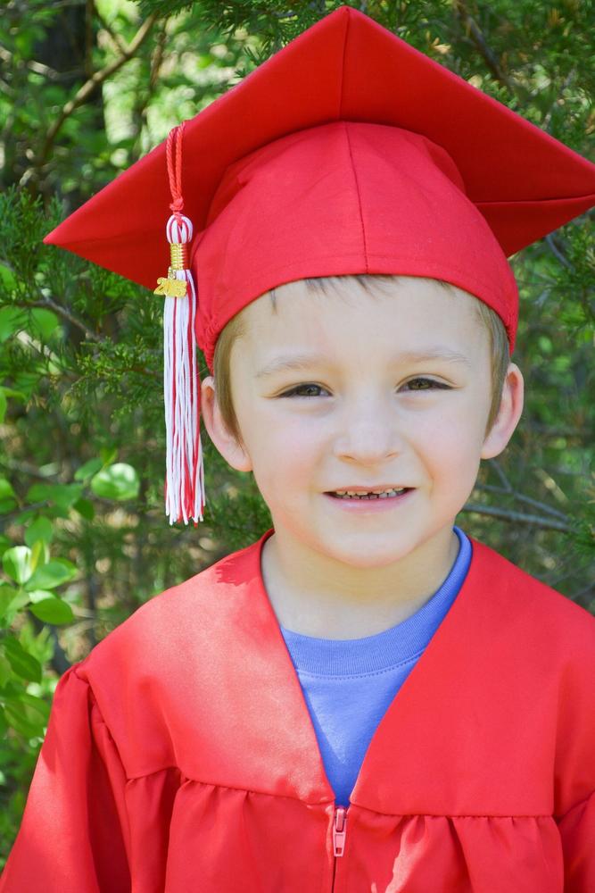 Bradence Jones wearing a red graduation cap and gown.