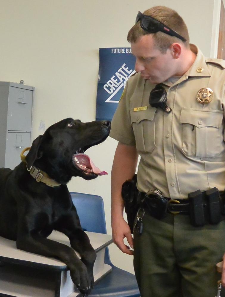 Deputy Ryan Reed standing by Otis.