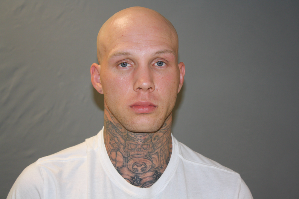Dillon C. Johnson in a white t-shirt and a tattooed neck.
