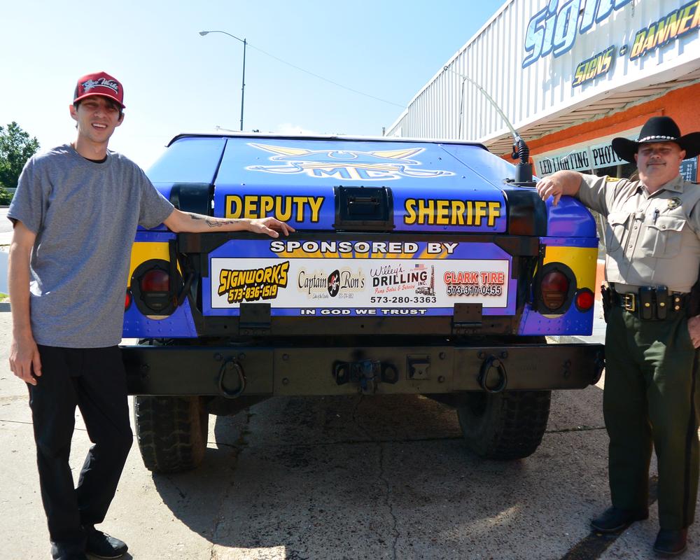 The public take picture in front of the Deputy Sheriff jeep.