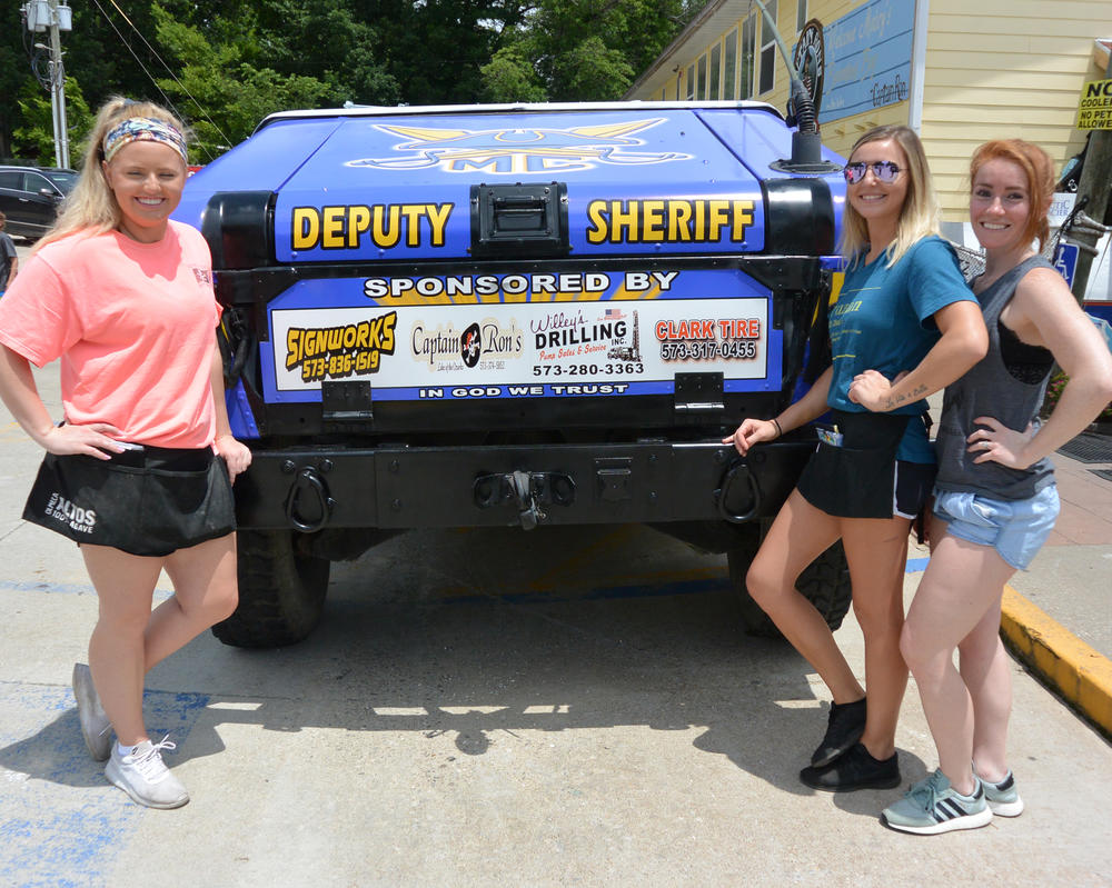 Girls taking a photo by the Deputy Sheriff's jeep.