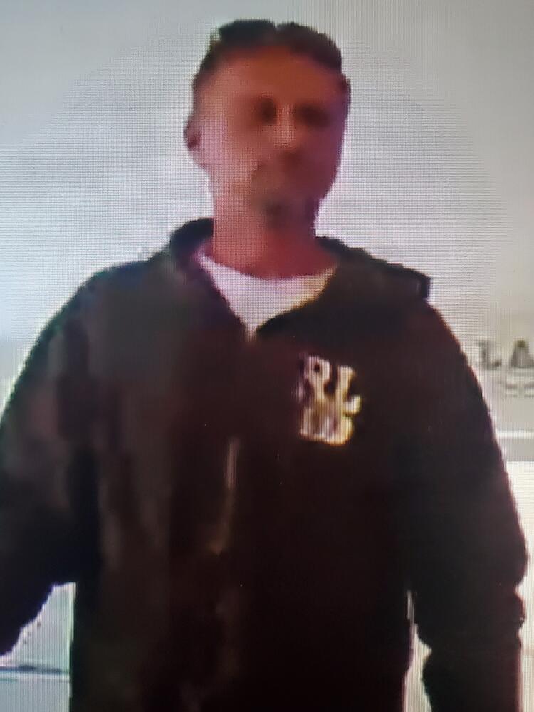 Burglary suspect 1. Man in a Brown jacket.
